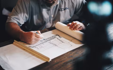 A construction manager looks over blueprint plans