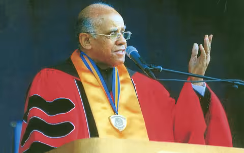 Leonard Slade, in regalia, speaks at a UAlbany Commencement