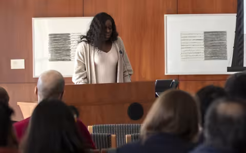 English Doctoral student Ola Kalu reads a Toni Morrison passage at the Toni Morrison tribute.