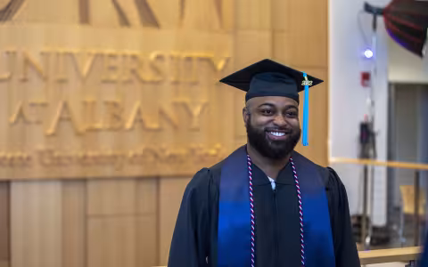 A person wearing a graduation cap and gown