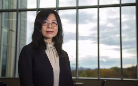 Dr. Yanna Liang, Department Chair of Environmental and Sustainable Engineering sits next to window