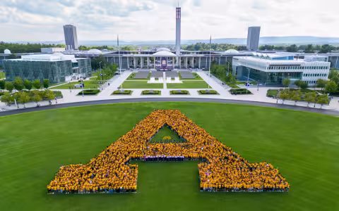 Students form a big UAlbany A standing together on a lawn on campus