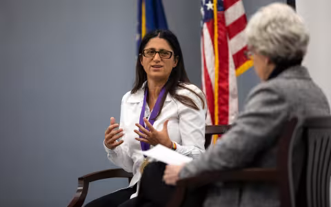 Mona Hanna-Attisha in a chair next to Mary Gallant as she speaks about her work on the Flint water crisis.