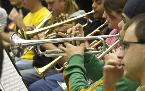 multiple musicians playing trumpets