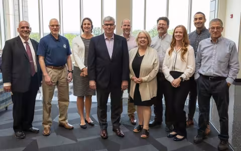 PNNL and DHS leaders stand with CEHC faculty at the ETEC atrium.