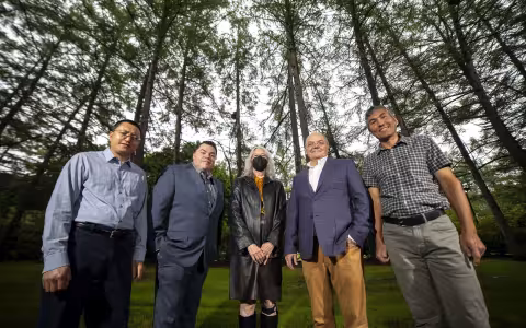 Department of Geography and Planning project researchers stand in front of a line of trees in the Academic Podium courtyard on the Uptown Campus.
