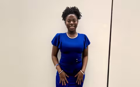 Kayla Rankin poses in a blue dress at her internship in Washington DC.
