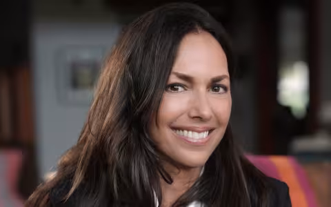 woman with brown hair smiles at camera