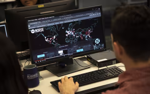 A student sits at a computer in the Digital Forensics Lab at UAlbany.
