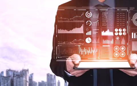 A person holding a tablet with graphs and data.