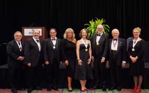 group of people dressed up wearing medals