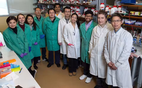 Max Royzen stands second from right with his lab team.
