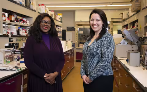 Rabi Musah and Allix Coon stand together in a chemistry lab.