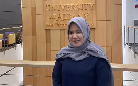 UAlbany PhD student and Graduate Ambassador Dwi Sari posing inside UAlbany's ETEC building.
