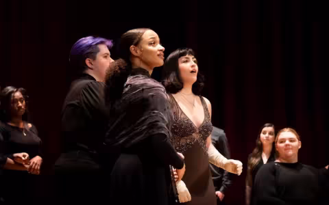 Several performers act and sing on stage