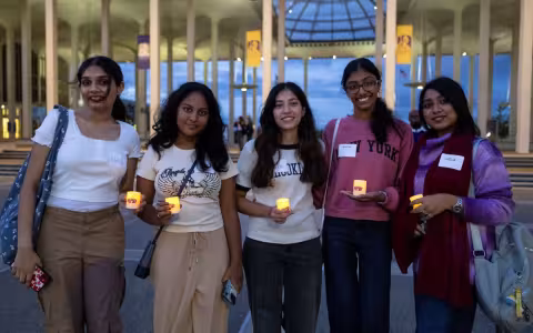 Students with candles during Welcome Week