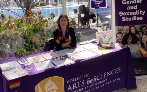 Professor Barbara Sutton at Fall Preview Day sitting at an information table with flyers and program hand-outs on October 27, 2024