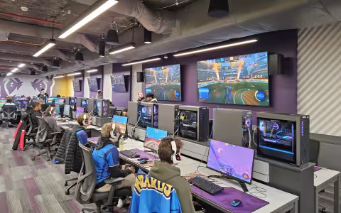 A row of students compete in Rocket League from gaming PCs inside the UAlbany Esports Arena.