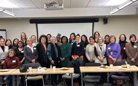 About two dozen UAlbany faculty members pose for a photo during the Spring 2025 Women in Science & Health (WISH) Welcome Lunch.