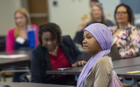 Student listening at a conference