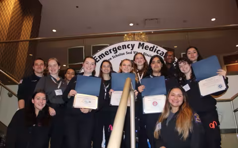 Five Quad student volunteers hold up awards at the National Collegiate Emergency Medical Services Foundation conference.