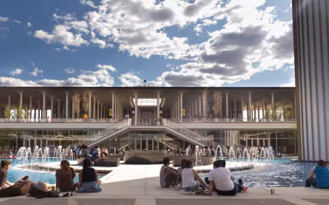 students enjoying lounging at the large fountain