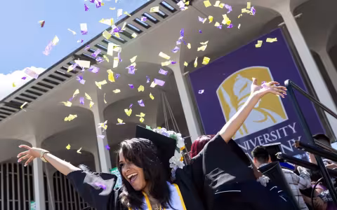 UAlbany graduate celebrates commencement with purple and gold confetti 