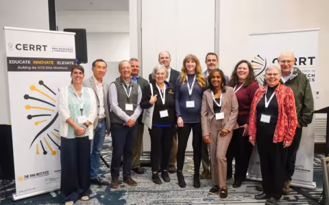 Group pose of smiling researchers at the Symposium.