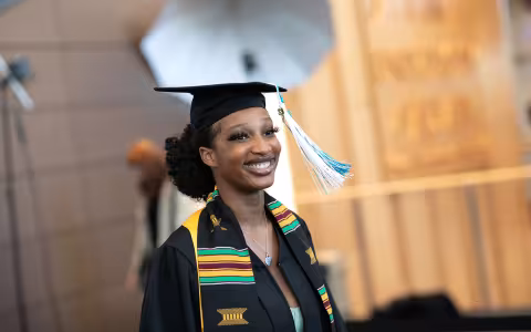 A student crosses the stage in the 2022 commencement at the UAlbany ETEC building