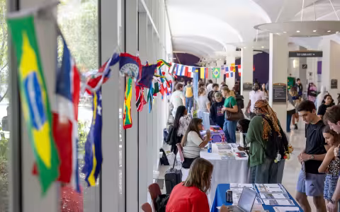 Students speak with staff members tabling an international education fair at UAlbany.