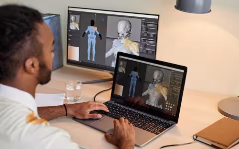 A 3D game artist develops a character on a laptop.