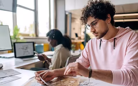 Video game designers work on a new game in a shared office space.