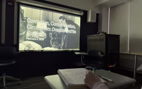 Students review a Dracula presentation slide in a UAlbany Honors College course.