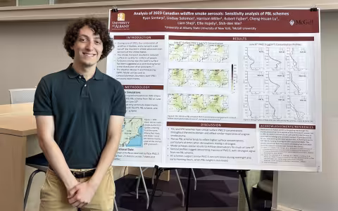 Ryan Sontarp stands in front of his poster at Showcase 2026.