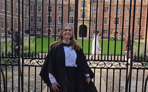 Kate Bucek of UAlbany stands in front of Cambridge University after receiving her graduate degree.