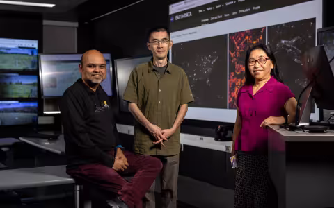 UAlbany researchers stand in front of screens inside the xCITE Laboratory at ETEC.