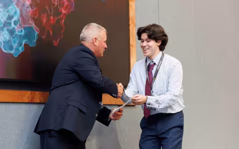 Packer receiving award for Best poster presentation on RNA Day summer celebration