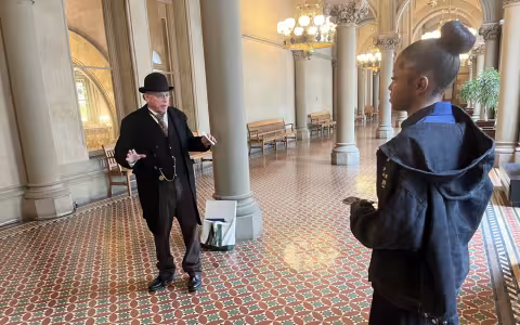 UAlbany student Almar Andre leads an interview from inside the State Capitol Building.
