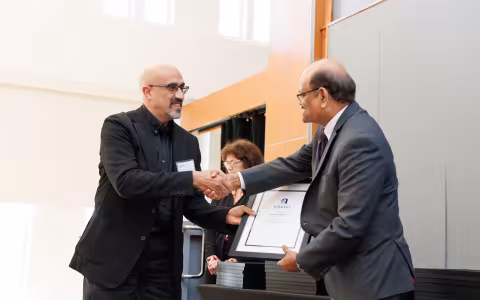 Professor Mohammed Agamy shakes hands with Thenkurussi Kesavadas.