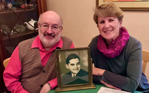 Robert & Diana Bangert-Drowns with a photo of Bob's uncle, Fr. Martin