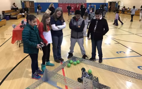 Kids and teacher working on robotics