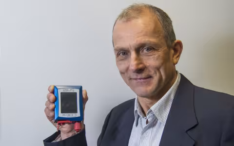 Chemist Igor Lednev displays a portable Raman spectrometer.