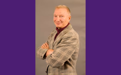 Photo of a man smiling at the camera.