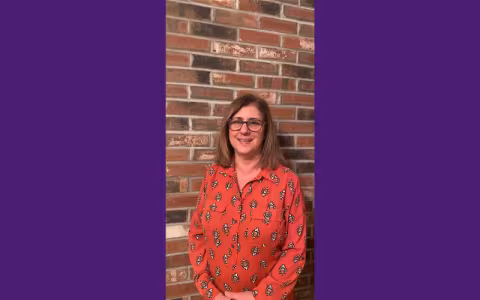 Woman smiling at camera.