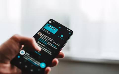 Photo of smartphone on Twitter with COVID-19 messaging