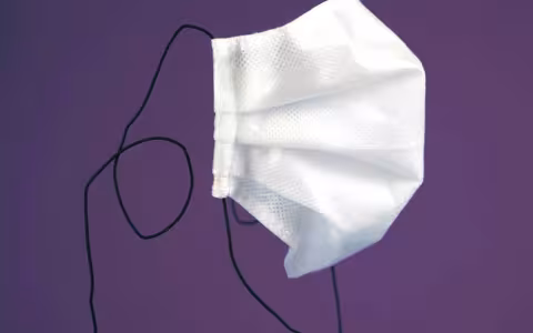 White mask on purple background.