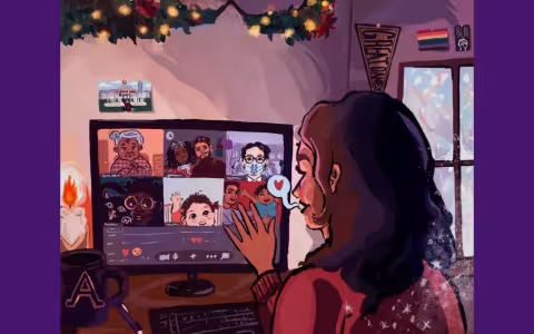 A woman waves to friends via Zoom on her computer