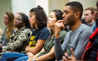 Graduate students several races sit in class in concentration