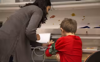Child and adult looking at a screen