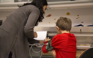 Child and adult looking at a screen